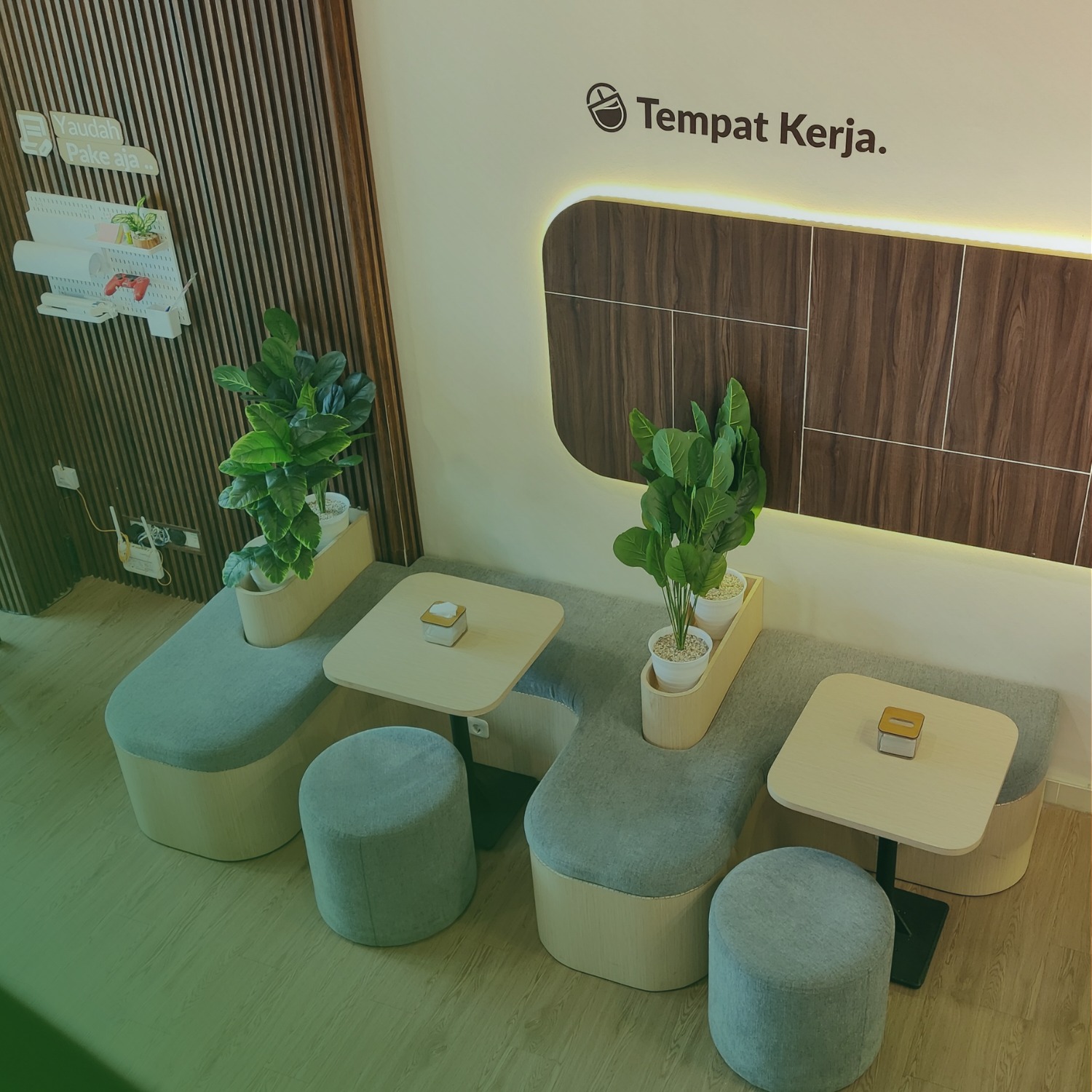 Tempat Kerja Interior - Modern coworking space with teal seating and plants